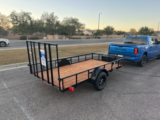 Carry On 6.3'×12' utility trailer hitched to blue Ram truck